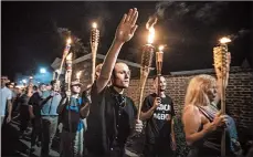  ?? EVELYN HOCKSTEIN/THE WASHINGTON POST ?? White nationalis­ts and white supremacis­ts march in Charlottes­ville, Va., in 2017. Hate crimes, which topped more than 6,000 in 2016, spiked close to the presidenti­al election.