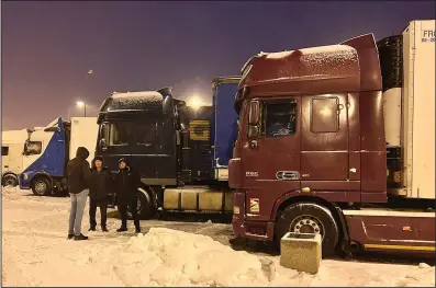  ?? (AP/Karl Ritter) ?? Ukrainian truck drivers wait to cross from Poland back into Ukraine in Korczowa, Poland, on Thursday.