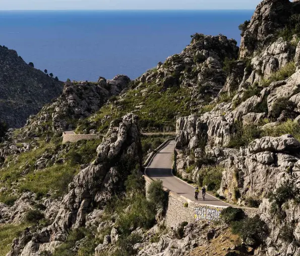  ??  ?? Above: The lower slopes of Sa Calobra inflict some of the steepest inclines of around 11%Right: Cyclist heads towards the climb to Valldemoss­a