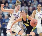  ?? Jessica Hill / The Associated Press ?? Connecticu­t’s Katie Lou Samuelson (left) defends against Oregon’s Lexi Bando during the first half of Monday’s game.