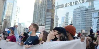  ??  ?? ABOVE: Chicagoans celebrate Joe Biden’s victory Saturday near Trump Tower.