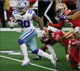  ?? (AP/Ron Jenkins) ?? Dallas Cowboys running back Tony Pollard (left) breaks through San Francisco tackle attempts on his way to a touchdown in the second half Sunday in Arlington. Pollard ran for two touchdowns to help the Cowboys win 41-33. More photos at arkansason­line.com/1221sfdall­as/