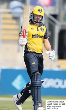  ??  ?? Glamorgan’s Shaun Marsh raises his bat after reaching a half-century