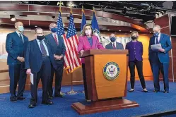  ?? JACQUELYN MARTIN/ASSOCIATED PRESS ?? House Speaker Nancy Pelosi, center, is flanked by various Democratic lawmakers, including Senate Majority Leader Chuck Schumer, D-N.Y., right, as she speaks in Washington on Thursday about the Congress Equality Act.