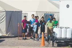  ?? Ivan Pierre Aguirre, Provided to The Associated Press ?? Migrant teenagers held inside the Tornillo detention camp look at protesters waving at them outside the fences in Texas this month.