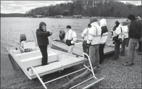  ?? NWA Democrat-Gazette/FLIP PUTTHOFF ?? Tony Lumpkin (left), boat designer, explains Nov. 21 the features of two rescue boats that were demonstrat­ed at Beaver Lake to firefighte­rs and other rescue personnel who respond to emergencie­s on the lake. For more photos, go to www.nwadg.com/photos.