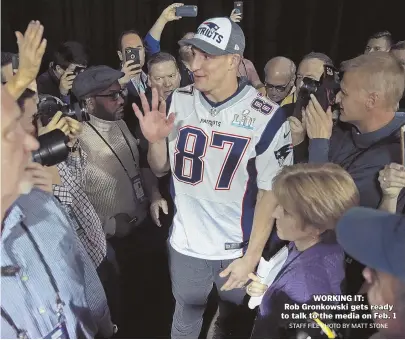  ?? STAFF FILE PHOTO BY MATT STONE ?? WORKING IT:
Rob Gronkowski gets ready to talk to the media on Feb. 1