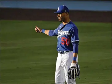  ?? MARK J. TERRILL / ASSOCIATED PRESS ?? Dodgers outfielder Mookie Betts, who was acquired in an offseason trade with the Red Sox, stands in right field during training for the 60-game regular season Monday in Los Angeles.