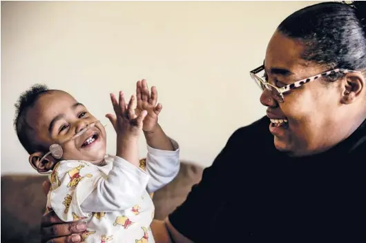  ?? BUTCH DILL/AP PHOTOS ?? Curtis Means plays with his mother, Michelle Butler, at their home in Eutaw, Alabama. The toddler stayed in the newborn intensive care unit for nine months after his birth.