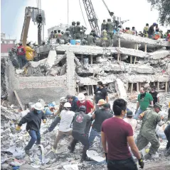  ??  ?? Rescuers, firefighte­rs, policemen, soldiers and volunteers search for survivors in a flattened building in Mexico City on Sept. 20, a day after a strong quake hit central Mexico.