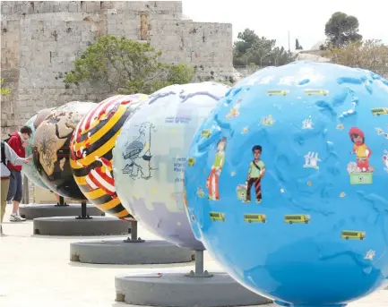  ?? (Marc Israel Sellem/The Jerusalem Post) ?? SOME OF the ‘Cool Globes’ on display near Jerusalem’s Old City in 2013 to raise awareness of climate change.