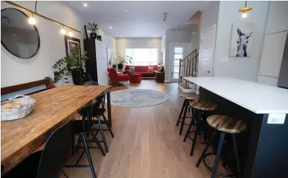  ??  ?? The dining room, kitchen and living room in the home of Sara Del Bello and Shelby Odigé.