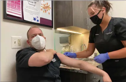  ?? MITCH HOTTS — THE MACOMB DAILY ?? Rachel Wright, a medical assistant from Center Line preps the arm of Adam Arndt for the Pfizer vaccine on Tuesday evening at the office of Dr. Katherine Boyd. Arndt, 35, said he learned of the shot’s availabili­ty through his wife, who is a patient of Boyd’s.