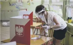  ??  ?? 0 Strict hygiene is adhered to on election day in Poland