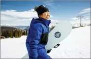  ?? JESSE DAWSON — BURTON SNOWBOARDS VIA AP ?? Patti Zhou, 11, carries her snowboard in Copper Mountain, Colo., April 9, 2022.