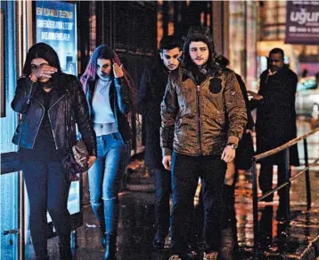 ?? STR/AP ?? Young people leave the scene of a nightclub attack in Istanbul early Sunday. Scores were injured in the attack.