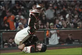  ?? JEFF CHIU — THE ASSOCIATED PRESS ?? Giants catcher Curt Casali falls backward after catching an out in foul territory hit by the San Diego Padres’ Fernando Tatis Jr. during the eighth inning Monday in San Francisco.