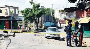  ?? FILE ?? Police start their probe metres from the bullet-riddled body of one of two men killed in Linstead, St Catherine, last Wednesday.