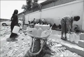  ?? Yahya Arhab
European Pressphoto Agency ?? RESIDENTS STOCK up on water in Sana, Yemen’s capital. About 270 miles northeast of the city, militants seized a base near the border with Saudi Arabia.