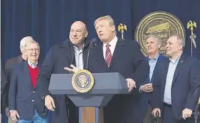  ?? Pool, Getty Images ?? President Donald Trump and National Economic Council director Gary Cohn affirm their support for each other at Camp David on Saturday.