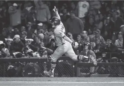  ?? Jonathan Daniel, Getty Images ?? Dodgers outfielder Enrique Hernandez celebrates after hitting his third home run of Thursday night’s NLCS Game 5 against the Cubs, a two-run shot in the ninth inning at Wrigley Field in Chicago. Hernandez had seven RBIs.