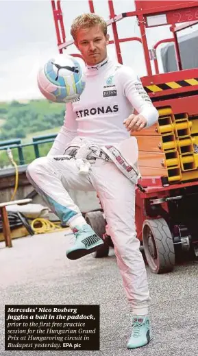  ??  ?? Mercedes’ Nico Rosberg juggles a ball in the paddock,
EPA pic