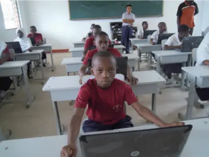  ??  ?? Students in a Hope Primary School in Tanzania get laptops