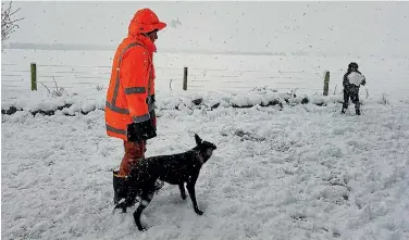  ?? PHOTO: JUNE YOUNGMAN ?? Kent Youngman enjoys the snow in Springfiel­d with his 10-year-old son Rydge and dog Tip. The area is 390 metres above sea level, so the folks there don’t freak out if they wake up to a half-metre of snow.