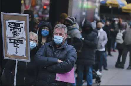  ?? SETH WENIG — THE ASSOCIATED PRESS ?? People wait in line at a COVID-19 testing site in Times Square, New York on Dec. 13. Scientists are warning that omicron’s lightning-fast spread across the globe practicall­y ensures it won’t be the last worrisome coronaviru­s variant.