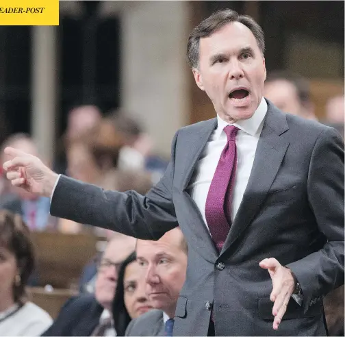  ?? ADRIAN WYLD / THE CANADIAN PRESS ?? Finance Minister Bill Morneau gestures at opposition MPs during question period in the House of Commons Thursday as he responds to accusation­s about a report his father had sold 200,000 Morneau Shepell shares ahead of a key tax announceme­nt.