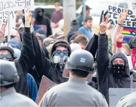  ?? AP FILE PHOTO ?? Demonstrat­ors are kept at bay by a line of police during a 2001 rally held by The World Church of the Creator in Wallingfor­d, where speech by white supremacis­t Matthew Hale brought protesters and police.