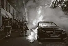  ?? Francois Mori / Associated Press ?? A car burns Saturday in Paris during a demonstrat­ion against a law that would restrict images of police. Civil liberties groups say it could allow police brutality to go unpunished.