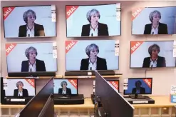  ?? — AFP ?? LIVERPOOL: Television­s are pictured on display for sale in a store in Liverpool, north-west England, yesterday as they show a live speech by British Prime Minister Theresa May on the government’s plans for Brexit.