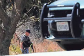  ??  ?? Deputies search the area where suspected gunman Santino William Legan may have entered as they investigat­e Sunday’s shooting.