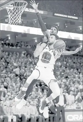  ?? JANE TYSKA — STAFF PHOTOGRAPH­ER ?? The Warriors’ Stephen Curry drives to the basket past the Denver Nuggets’ Malik Beasley.