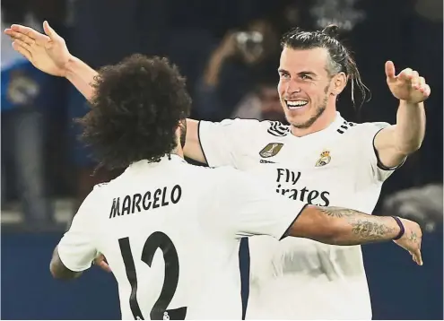  ?? — AP ?? Three’s enough: Real Madrid midfielder Gareth Bale (right) celebratin­g with teammate Marcelo after scoring his side’s third goal during the Club World Cup semi-final match against Kashima Antlers on Wednesday.