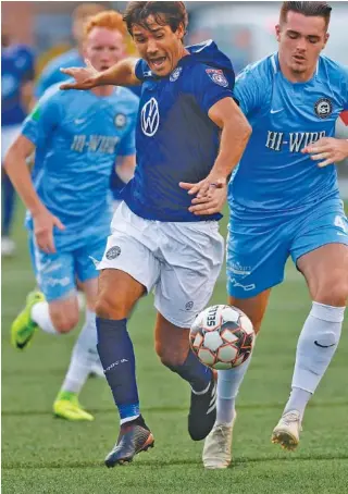  ?? STAFF PHOTO BY DOUG STRICKLAND ?? The Chattanoog­a Football Club’s Jose “Zeca” Ferraz tries to get clear of Asheville City’s Jamie Smith, right, in an NPSL Southeast match at Finley Stadium on June 29. Both teams will be back there today for conference semifinals at 4:30 and 7:30 p.m.