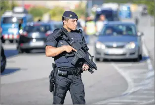  ?? AP PHOTO ?? An armed police officer stands guard near Subirats, Spain, on Monday where Spanish police shot and killed the last member of a terror cell believed to be behind last week’s deadly attack in Barcelona.