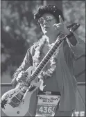  ?? KARL MONDON — STAFF PHOTOGRAPH­ER ?? Henry Chan carries an inflatable guitar while running as Elvis Presley in the San Jose Rock ‘n’ Roll half marathon on Sunday.