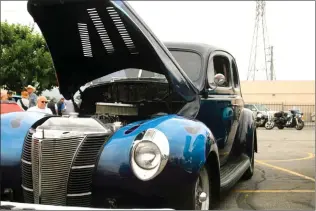  ?? Skylar Barti/The Signal ?? (Above) One of the classic rides on display, a 1940 Ford, at the fourth annual Car Show and Chili Cook-Off at Our Lady of Perpetual Help Church on Saturday. (Left) Jay Fithian, grand knight of OLPH Knights of Columbus, stands next to his wheels during...