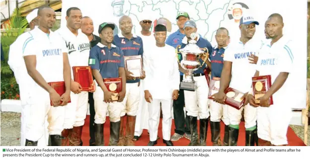  ?? Vice President of the Federal Republic of Nigeria, and Special Guest of Honour, Professor Yemi Oshinbajo (middle) pose with the players of Almat and Profile teams after he presents the President Cup to the winners and runners-up, at the just concluded 12- ??