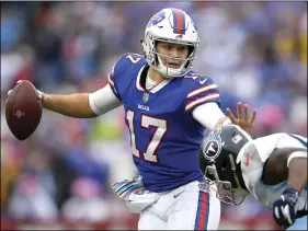  ?? AP PHOTO/ADRIAN KRAUS ?? In this Oct. 7 file photo, Buffalo Bills quarterbac­k Josh Allen (left) tries to avoid a tackle from Tennessee Titans linebacker Sharif Finch during the second half of an NFL football game in Orchard Park, N.Y.