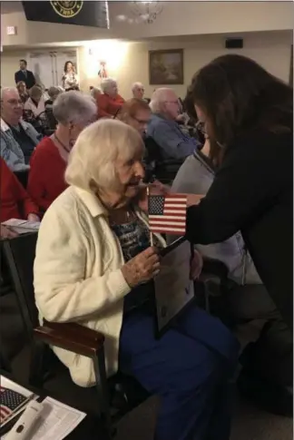  ?? GINGER RAE DUNBAR – DIGITAL FIRST MEDIA ?? Wellington at Hershey’s Mill resident and U.S. Navy veteran Ruth Snyder, who served from 19441945, receives a pin and certificat­e during the Veterans Day pinning ceremony at Wellington at Hershey’s Mill.