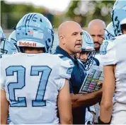  ?? Brian A. Pounds/Connecticu­t Post ?? Oxford football coach Joe Stochmal huddles with his team before playing Seymour on Sept. 21. Stochmal the only coach in the history of the Oxford program, is stepping down after 17 seasons.