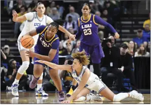  ?? (AP/Hans Pennink) ?? LSU guard Mikaylah Williams (12) scrambles to maintain control of the ball Saturday against UCLA guard Kiki Rice (1) during the fourth quarter the Tigers’ 78-69 win in the Sweet 16 of the women’s NCAA Tournament in Albany, N.Y. Williams scored 12 points as LSU moved on to a rematch of last year’s national title game with Iowa.