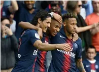  ?? AFP ?? PSG’s Kylian Mbappe (centre) is congratula­ted by Neymar (right) and Edinson Cavani after scoring a goal. —