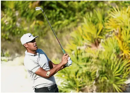  ??  ?? All eyes: Tony Finau of the United States watches his shot on the 16th green during round three of the Hero World Challenge at Albany, Bahamas on Saturday. — AFP