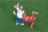  ?? (AFP) ?? England’s forward Harry Kane (L) and Iran’s defender Morteza Pouraligan­ji collide during their FIFA World Cup Qatar 2022 Group B match at the Khalifa Internatio­nal Stadium in Doha on Monday.