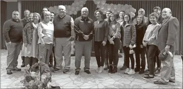  ?? John Bailey ?? Members of the families of Chief Deputy Tommy McGuire and Sheriff Tim Burkhalter lined up for a photo after a ceremony on Friday honoring the two men on the eve of their retirement.