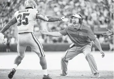  ?? Sean Rayford / Associated Press ?? Georgia coach Kirby Smart, right, is ready to celebrate with running back Brian Herrien, who scored on a 15-yard run in the third quarter of the No. 3 Bulldogs’ 41-17 rout of No. 24 South Carolina at Columbia, S.C.